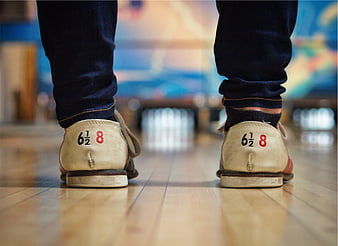 Close-up of bowling shoes on a wooden lane
