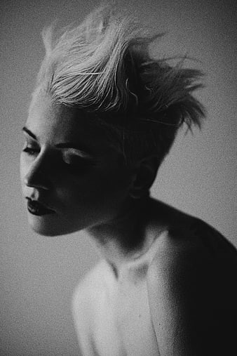 Dramatic black and white portrait of woman with short hair