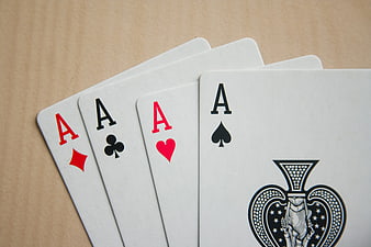 Four Aces of Spades, Hearts, Clubs, and Diamonds on Wood