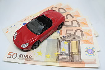 Red toy sports car on 50 euro banknotes