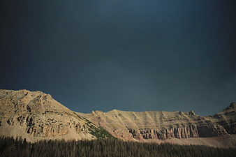 Dramatic Rocky Mountain Ridge Under Dark Blue Sky