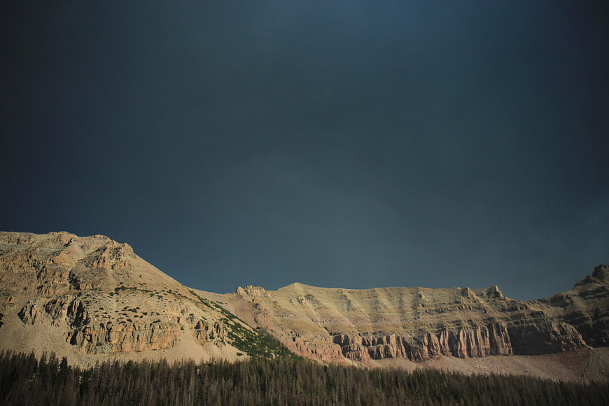 Dramatic Rocky Mountain Ridge Under Dark Blue Sky