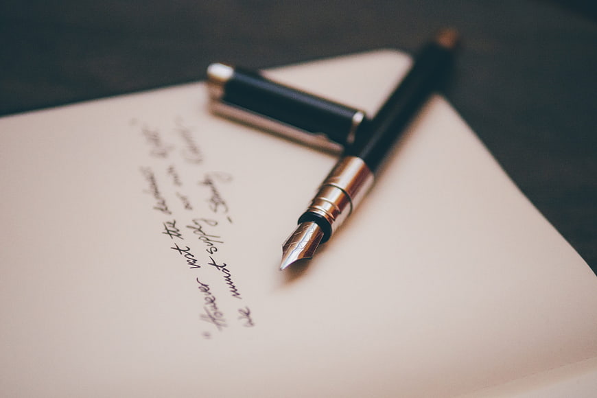 Vintage fountain pen on handwritten notebook page