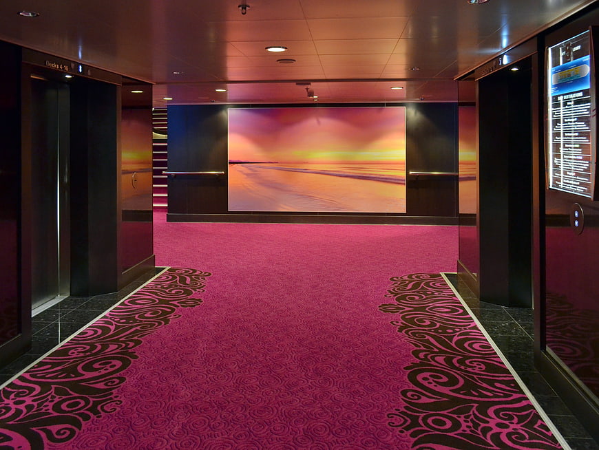 Luxury Cruise Ship Corridor With Pink Carpet And Elevators