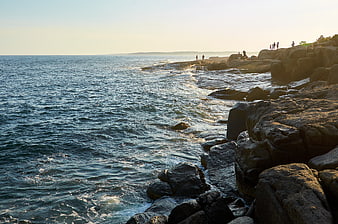 Scenic Rocky Coastline with Ocean Waves and People