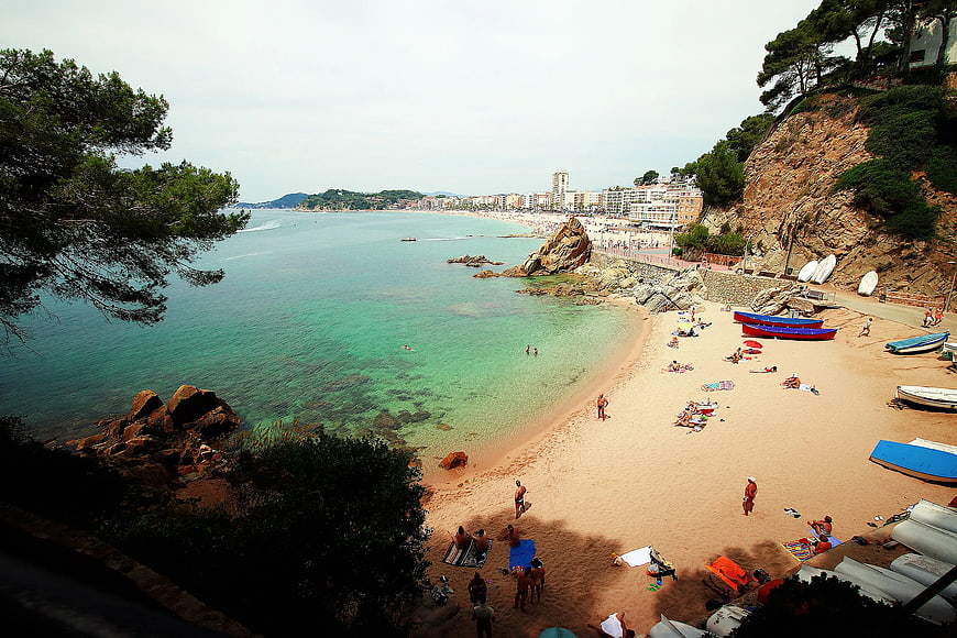 High Angle View of Sunny Beach with Turquoise Water and Town