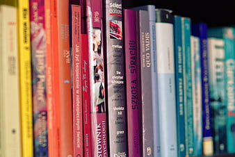 Colorful book spines on a shelf with shallow depth of field