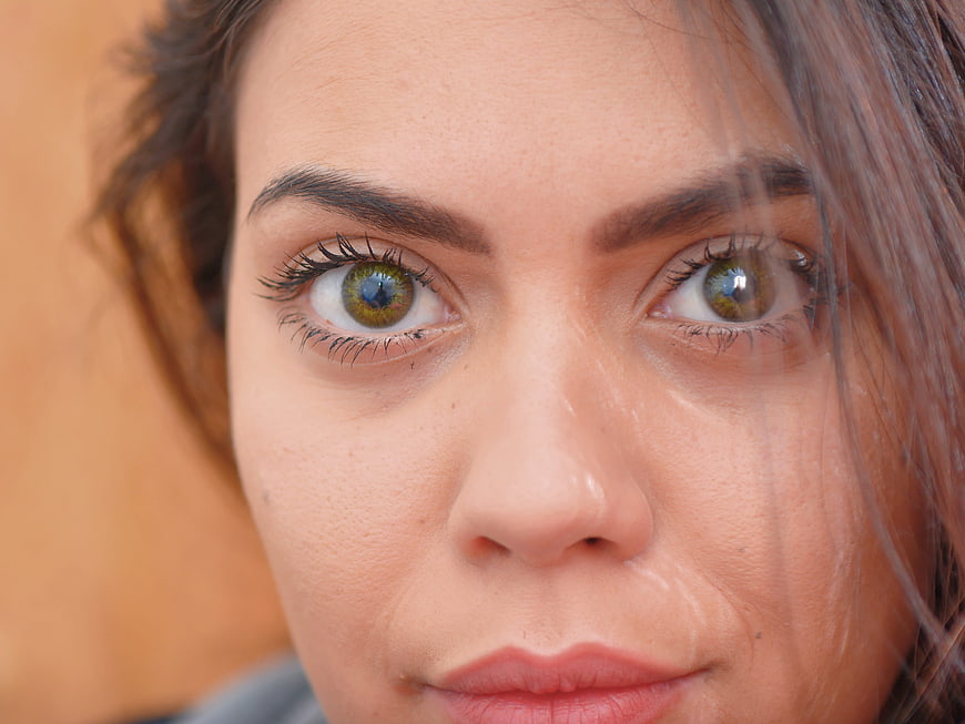 Close-up portrait of woman with striking green eyes