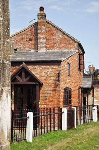 Red Brick Canal Cottage with Black Iron Fence