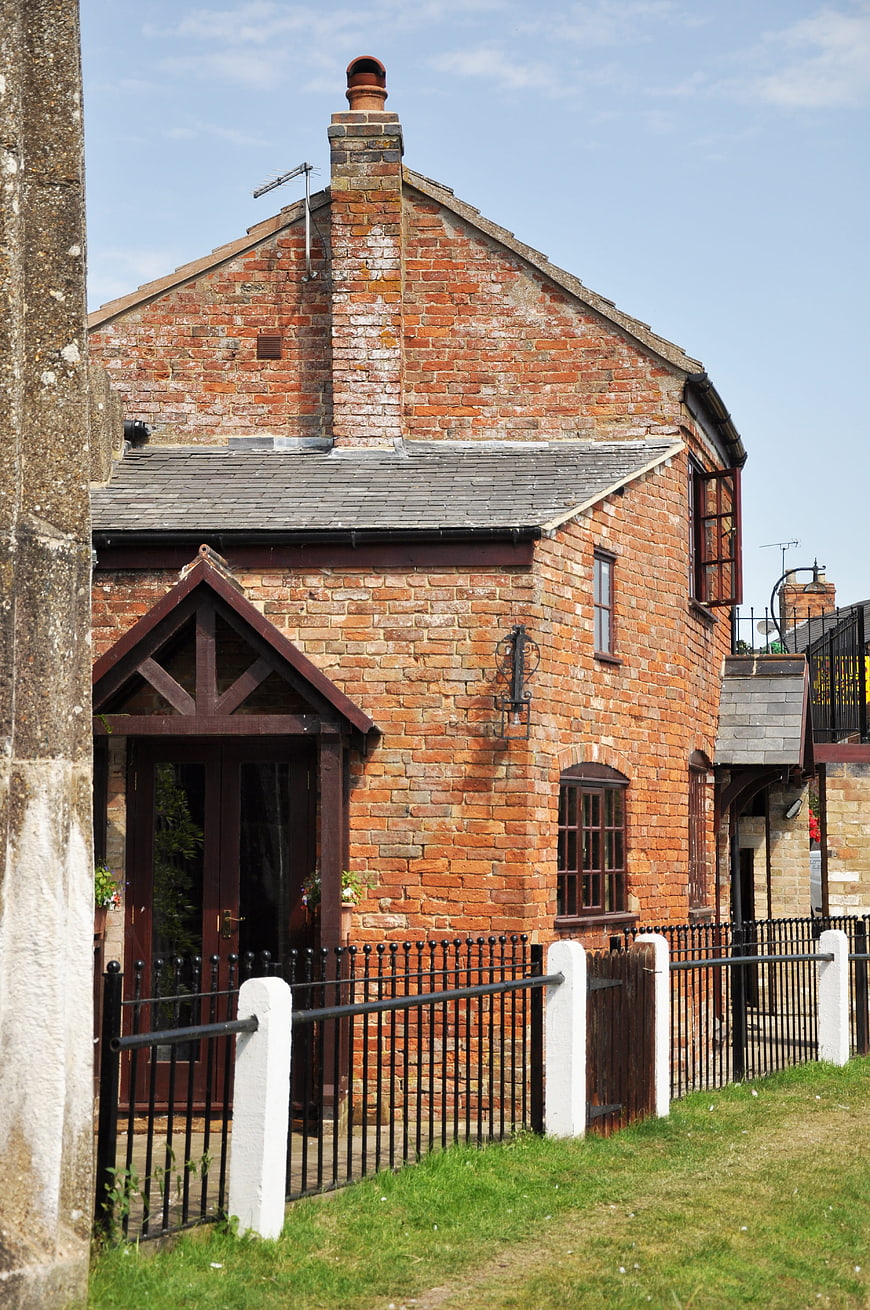 Red Brick Canal Cottage with Black Iron Fence