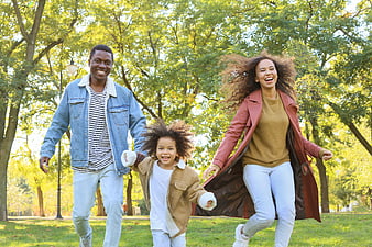 Happy African American Family Running in Park