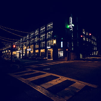 Nighttime Urban Street Scene with Crosswalk and Neon Signs