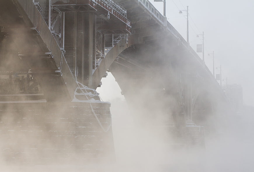 Foggy industrial steel bridge architecture in winter
