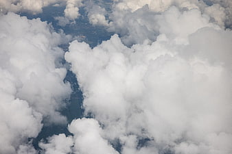 Aerial View of Fluffy White Cumulus Clouds Over Blue Sky