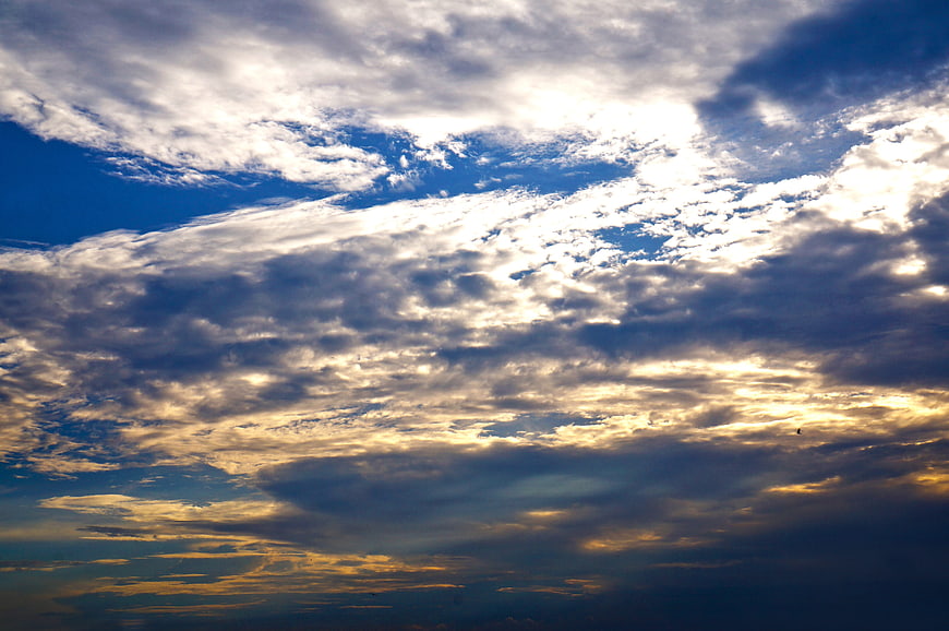 Dramatic sunset sky with textured clouds and golden light