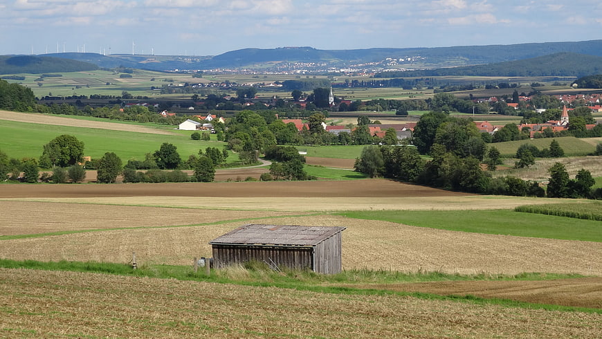 Rural landscape with wooden shed and distant village