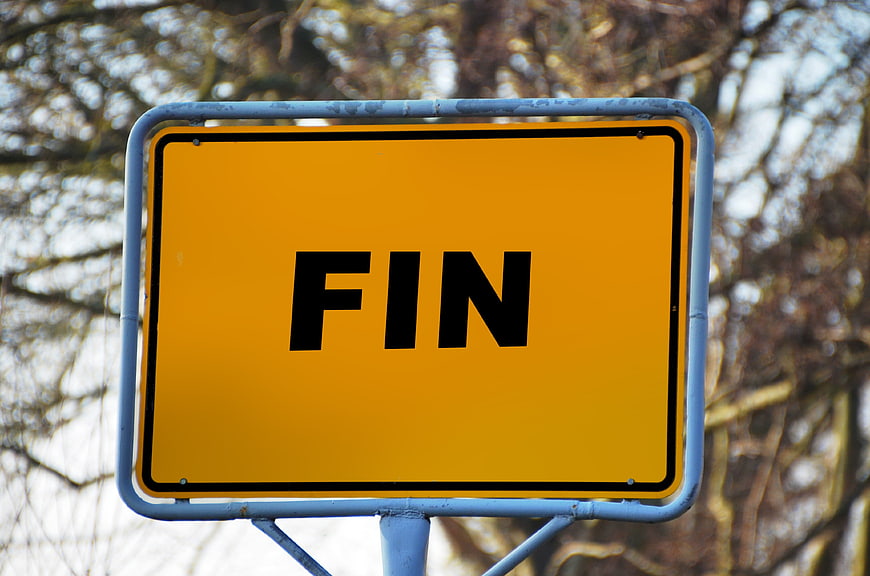 Yellow FIN Road Sign Against Blurred Tree Background