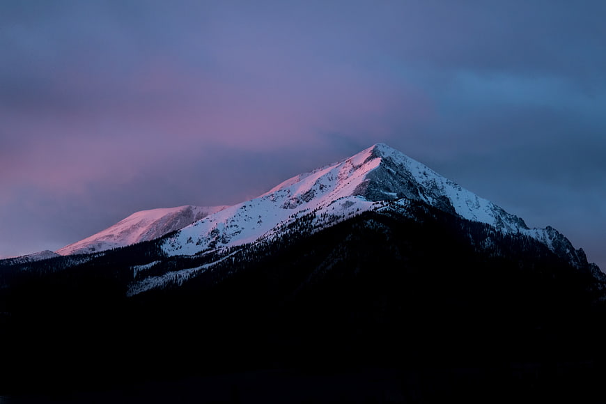 Snow-Capped Mountain Peak at Twilight with Pink Alpenglow
