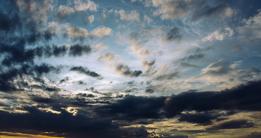 Dramatic sunset sky with dark clouds and golden light