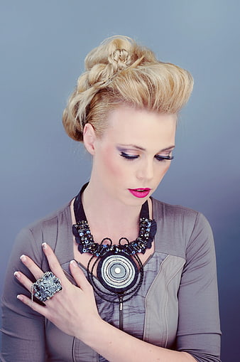 Blonde Woman with Braided Updo and Statement Jewelry