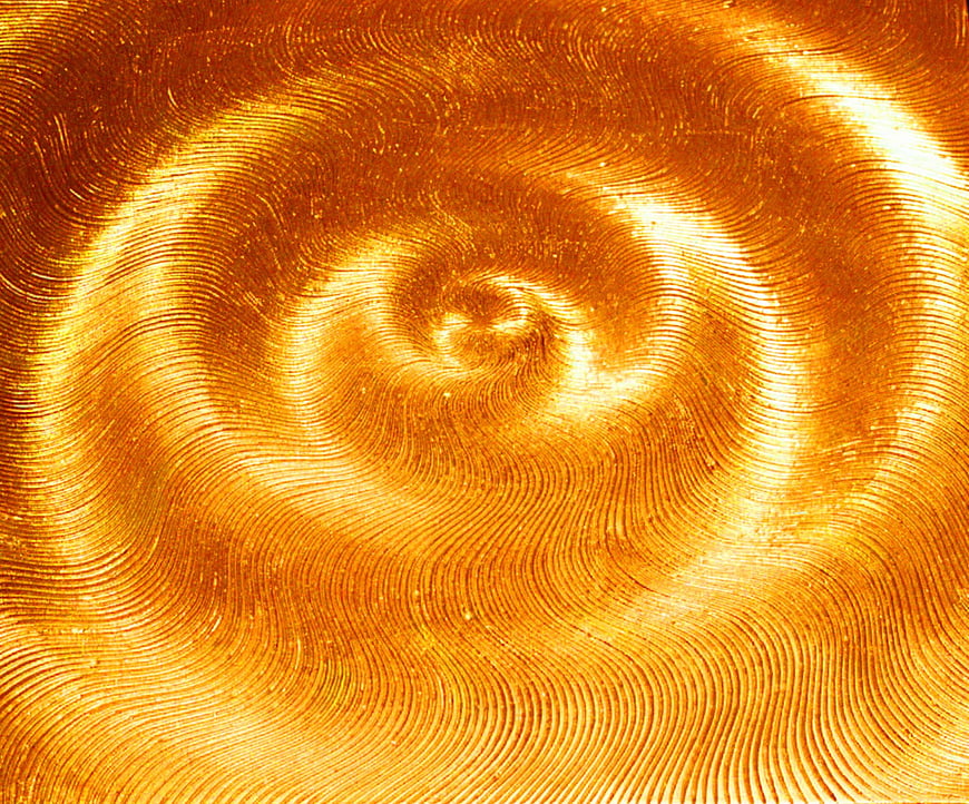 Abstract golden spiral pattern with swirling light and wave textures