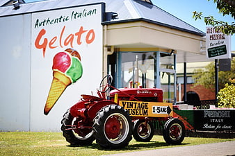 Vintage Red Tractor in Front of Gelato Shop