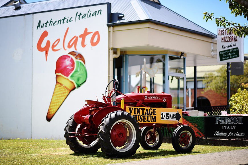 Vintage Red Tractor in Front of Gelato Shop