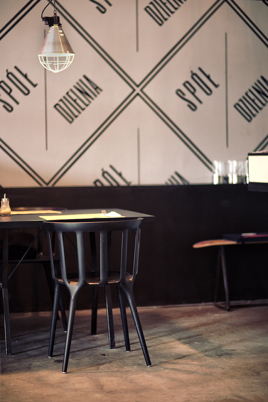 Modern industrial restaurant interior with black chair and table