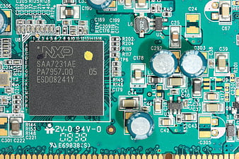Macro shot of NXP SAA7231AE chip on green circuit board