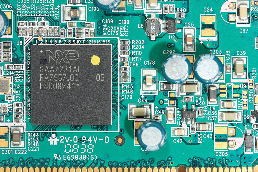 Macro shot of NXP SAA7231AE chip on green circuit board
