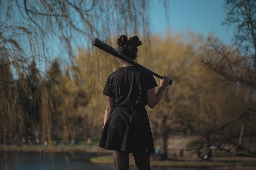 Woman holding baseball bat in park