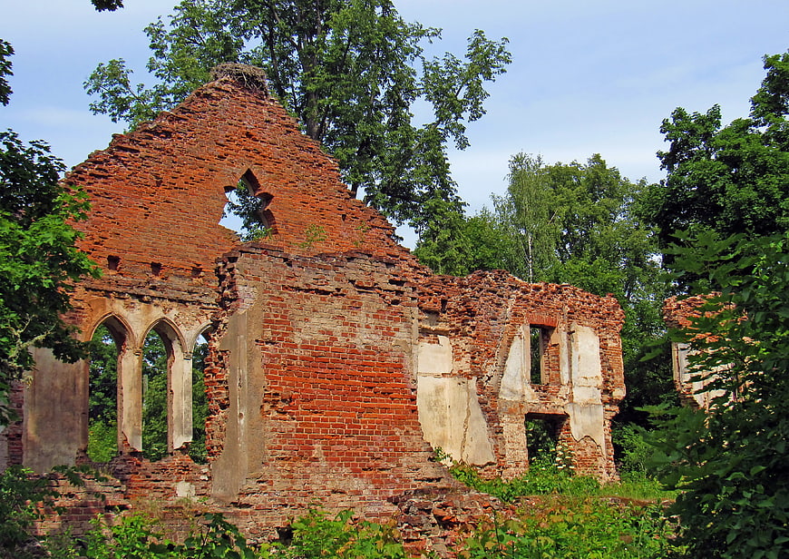 Ruins of an old red brick building in a forest