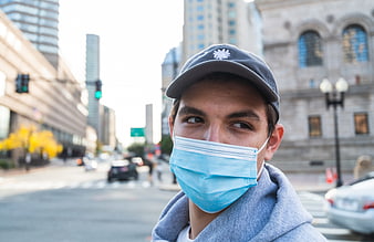 Young man wearing face mask on city street
