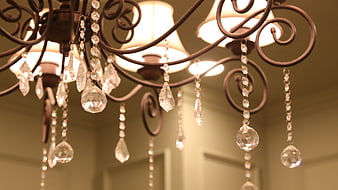 Close-up of ornate wrought iron chandelier with crystal pendants