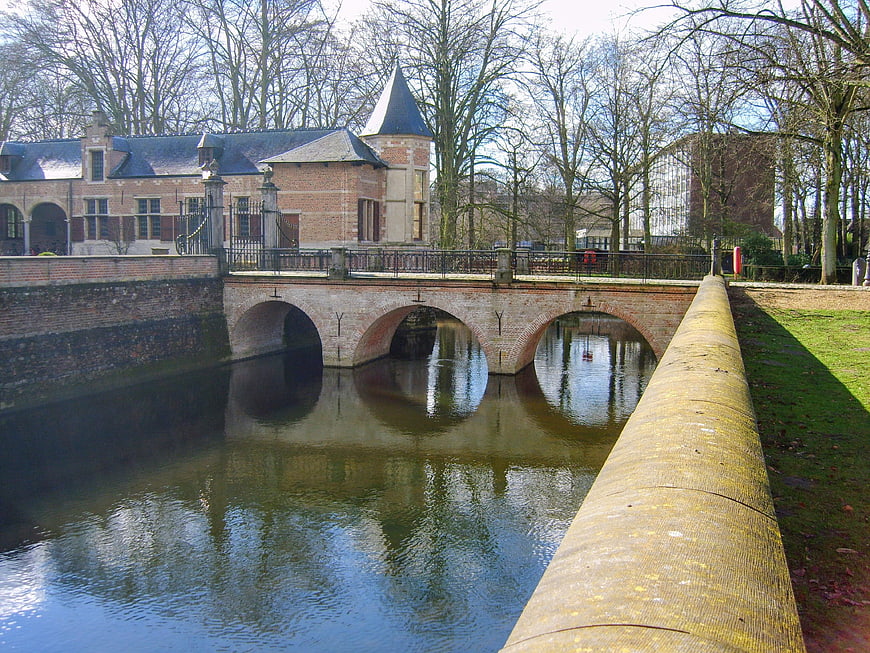 Historic brick bridge over canal with castle in Antwerp