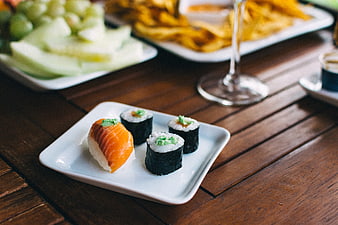 Sushi nigiri and maki rolls on a wooden table