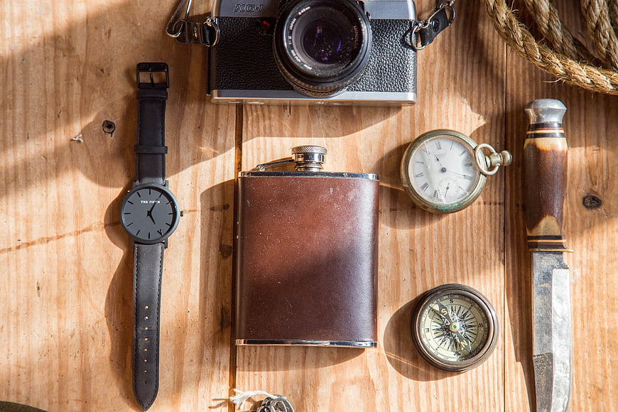 Vintage adventure gear flat lay on wooden table