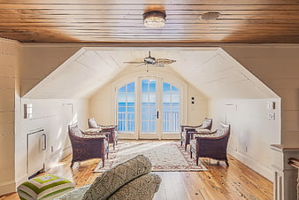 Cozy Attic Room with Ocean View and Wicker Chairs