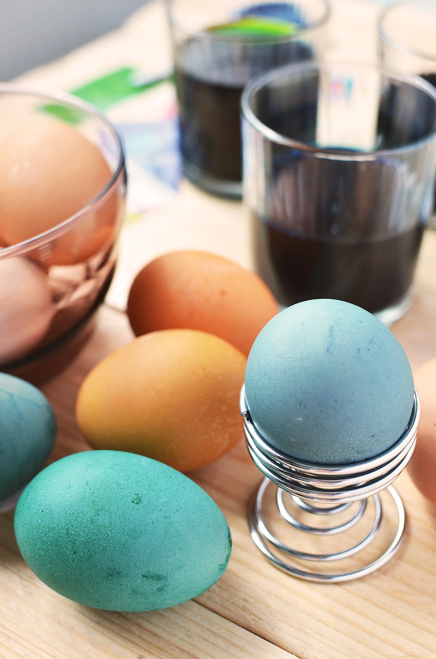 Colorful Easter Eggs with Dye and Wooden Background