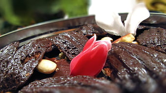 Close-up of chocolate brownies with nuts and flower garnish