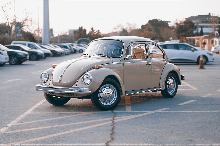 Vintage Beige Volkswagen Beetle in Parking Lot