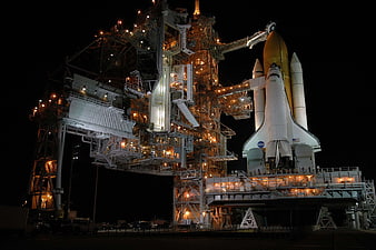 Space Shuttle Discovery on Launch Pad at Night