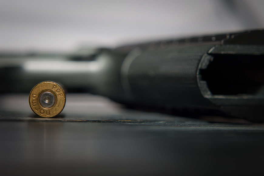Macro shot of a 9mm bullet and pistol barrel