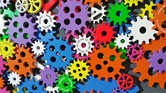 Colorful Plastic Gears Arranged In A Dense Mechanical Pattern