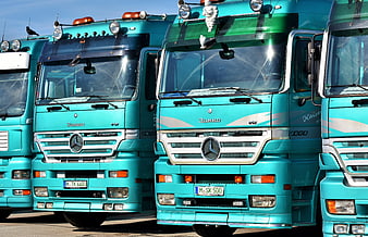 Row of Teal Mercedes-Benz Trucks Parked in a Line