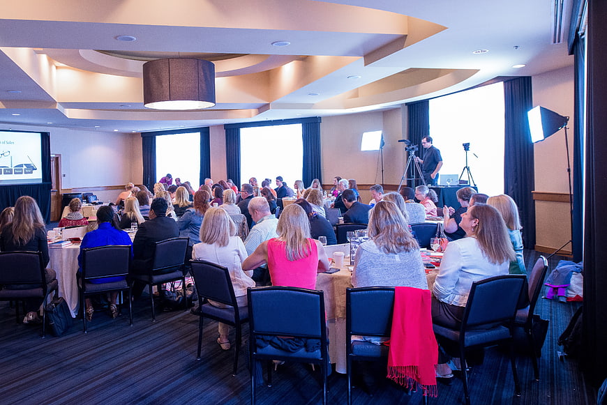 Corporate conference presentation with audience in hotel ballroom