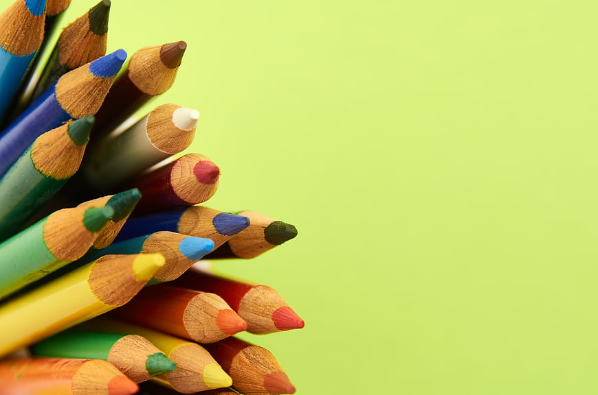 Colorful Colored Pencils on Lime Green Background