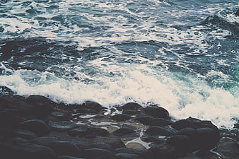 Ocean Waves Crashing on Dark Rocky Shore