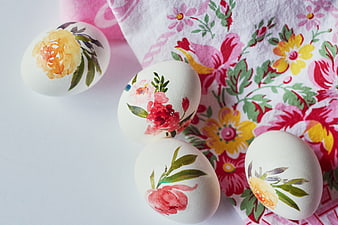 Hand-painted floral Easter eggs on floral cloth