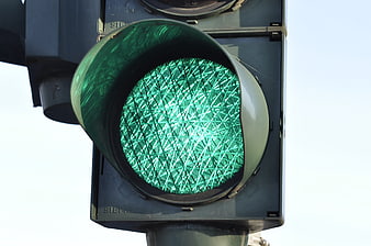 Close-up of Green Traffic Light Signal Against Sky